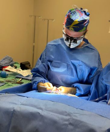 a person wearing surgical gear and gloves